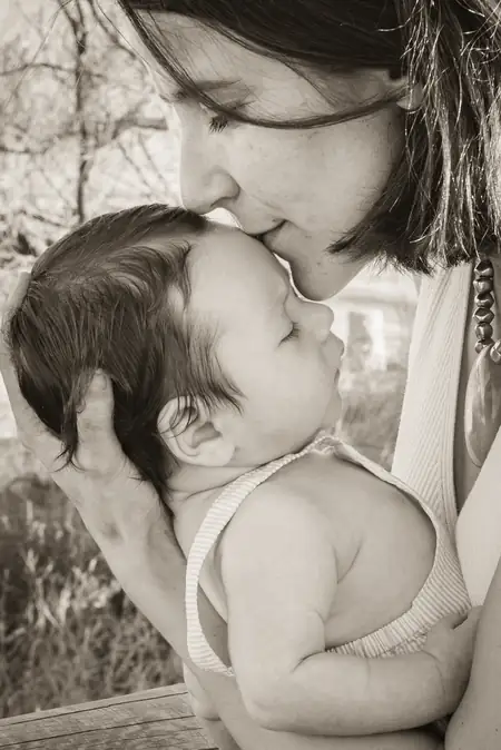 Padre levantando a su hijo en la playa al atardecer